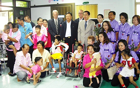 Staff and visitors gather round for a commemorative photo.